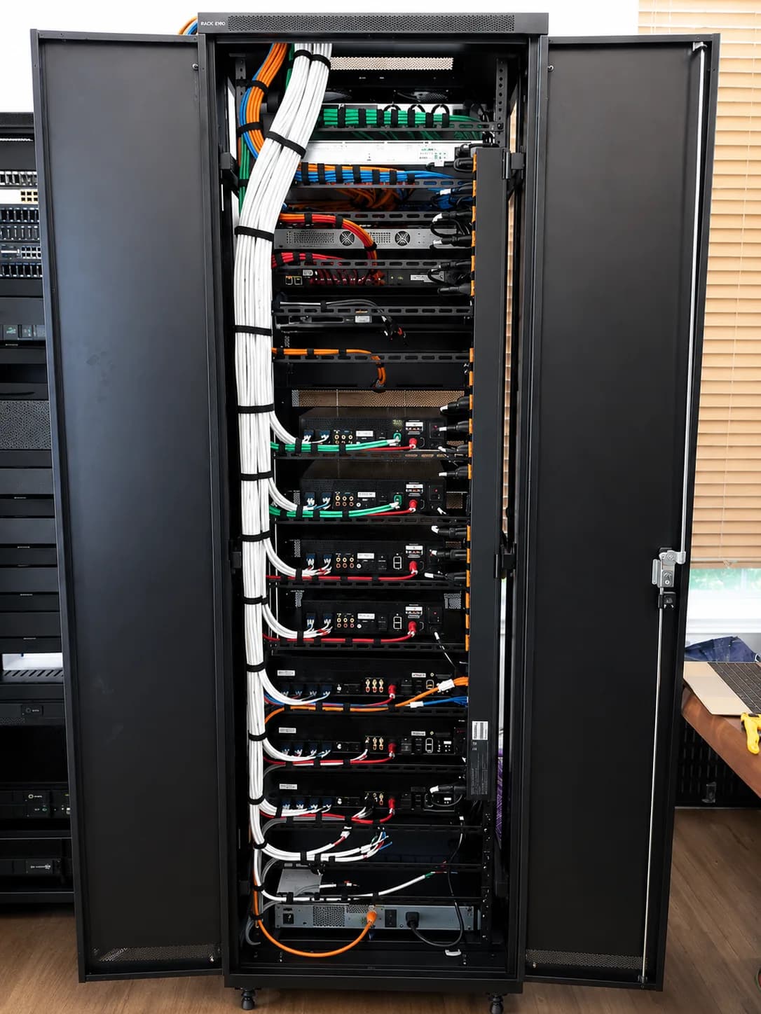 A network server rack with structured cabling, switches, and patch panels